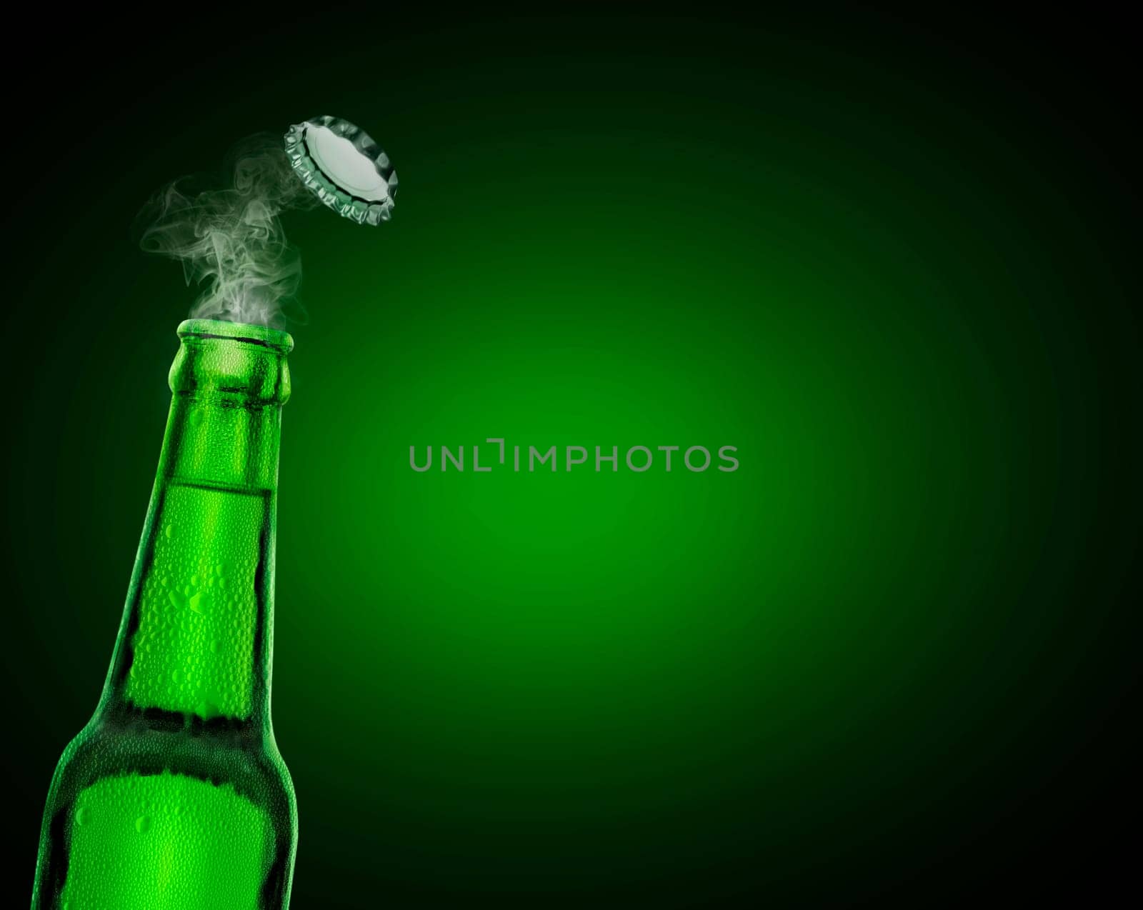 cold wet open beer bottle with smoke on green background