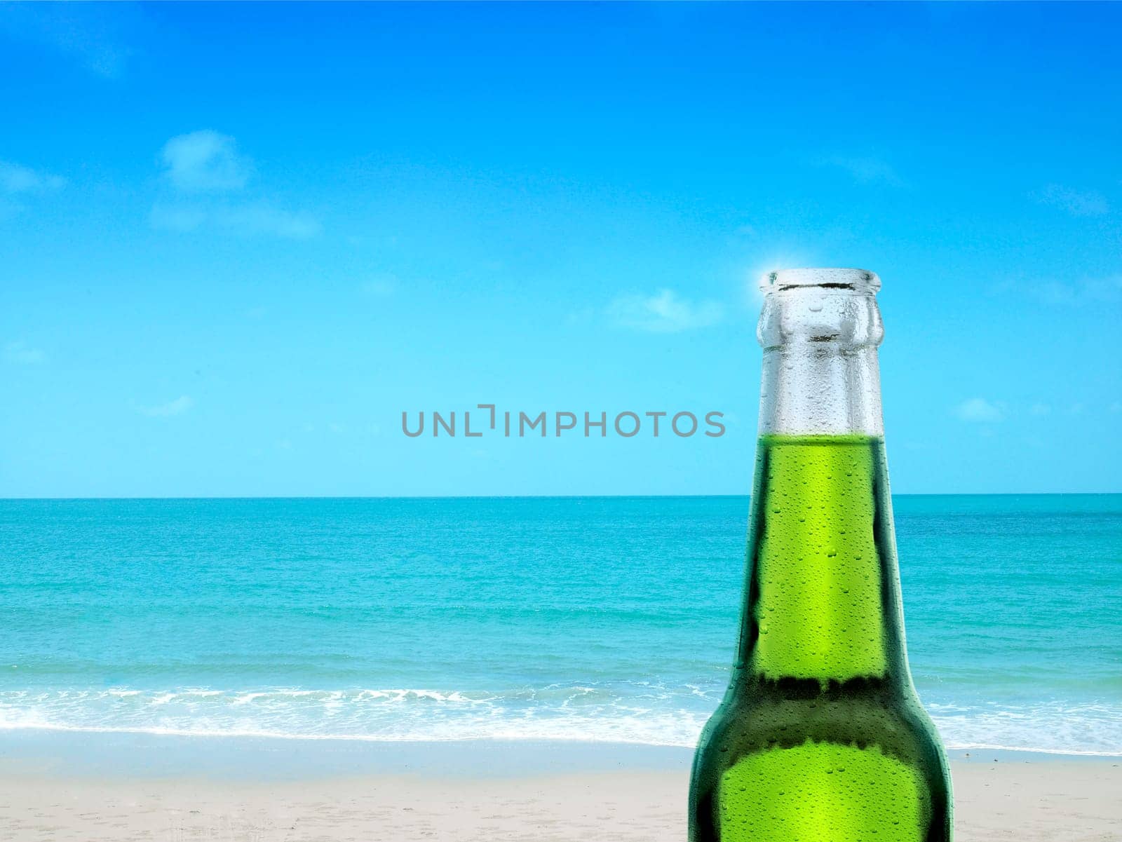 recently opened beer bottle on beautiful beach and tropical sea. Tropical landscape