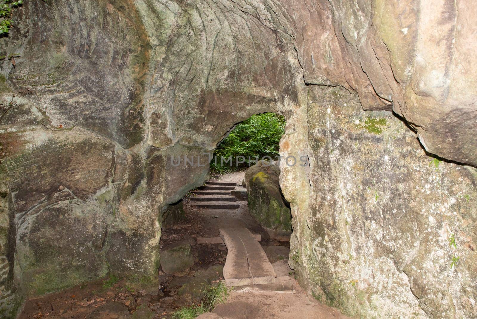 Huel Lee or Hohllay on the Mullerthal trail in Luxembourg, open cave with view to the forest, sandstone rock formation