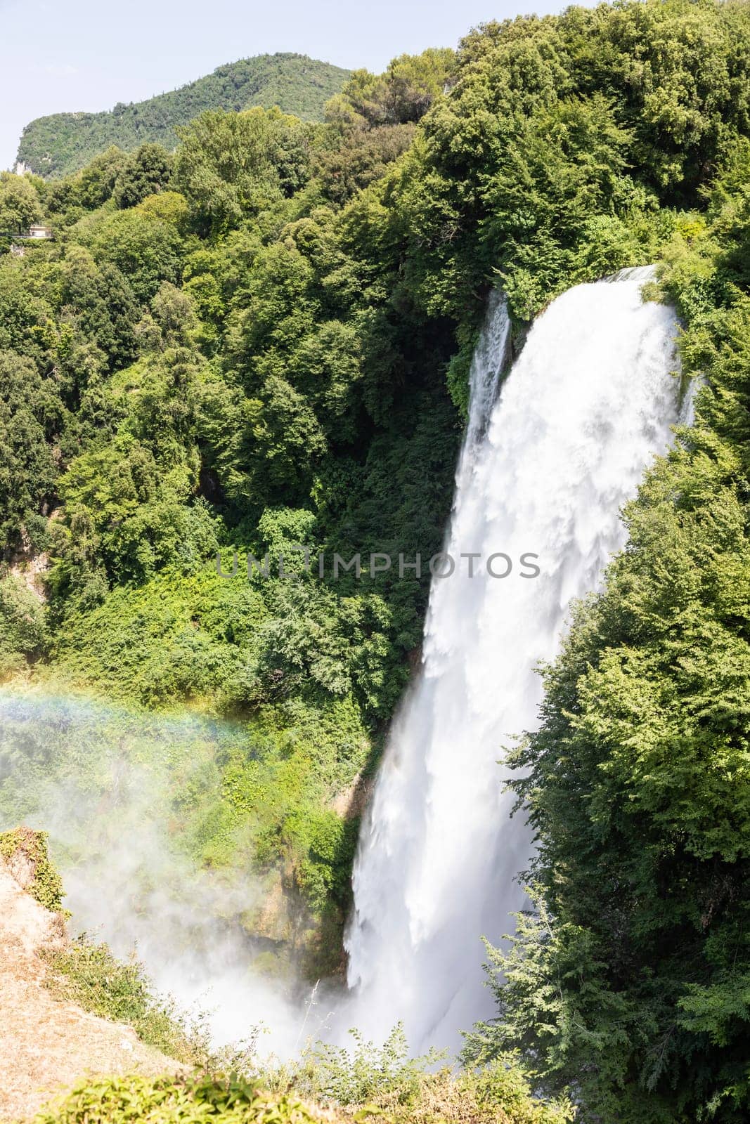 Marmore waterfall in Umbria region, Italy. Amazing cascade splashing into nature with trees and rocks.