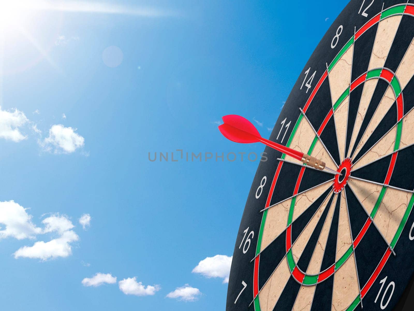 Darts with dartboard with blue sky background concept for hitting target, goal and success