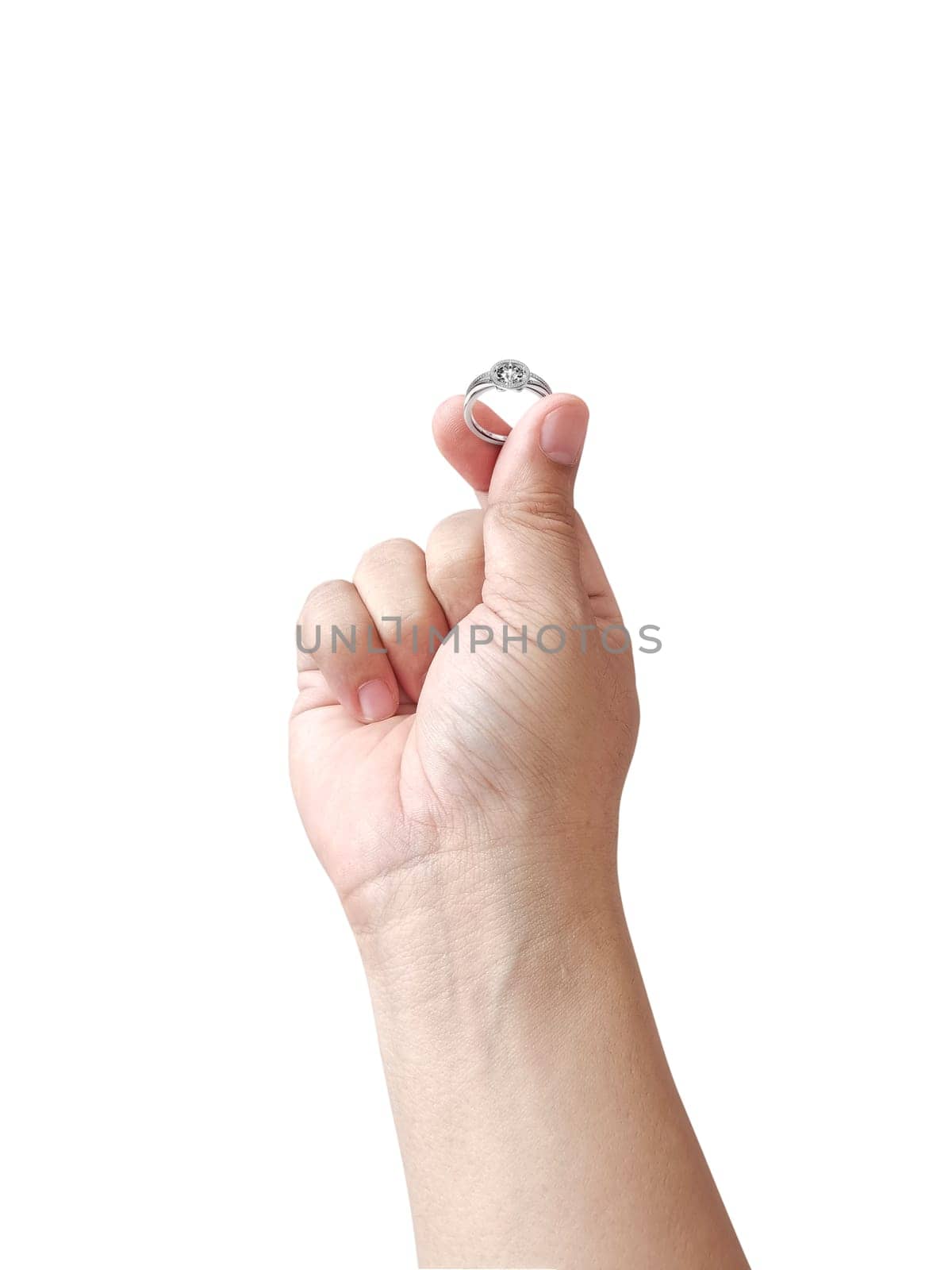 Hand holding diamond ring isolated on white background