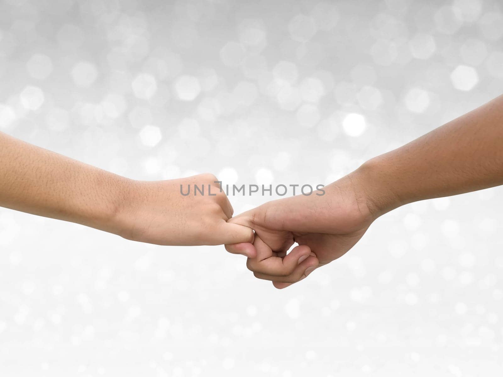 Image of a couple holding hands on shining bokeh background