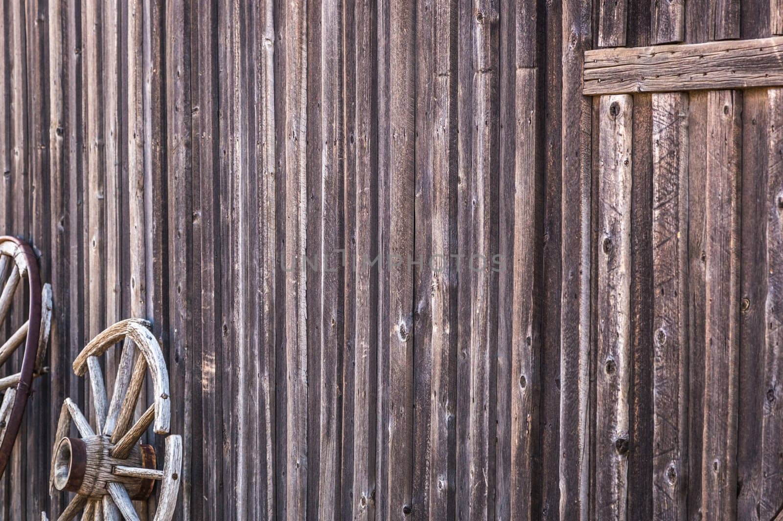 Abstract of Vintage Antique Log Cabin Wall and Wagon Wheel.