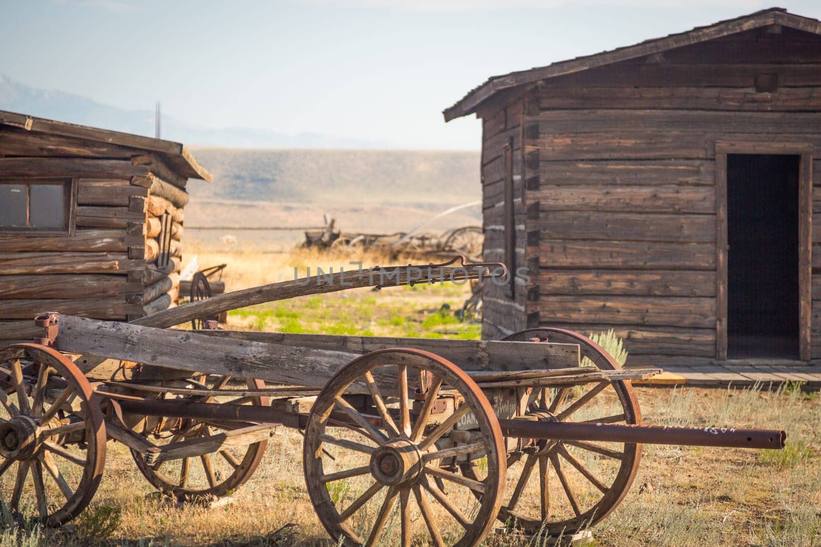 Abstract of Vintage Antique Wood Wagon and Log Cabins.