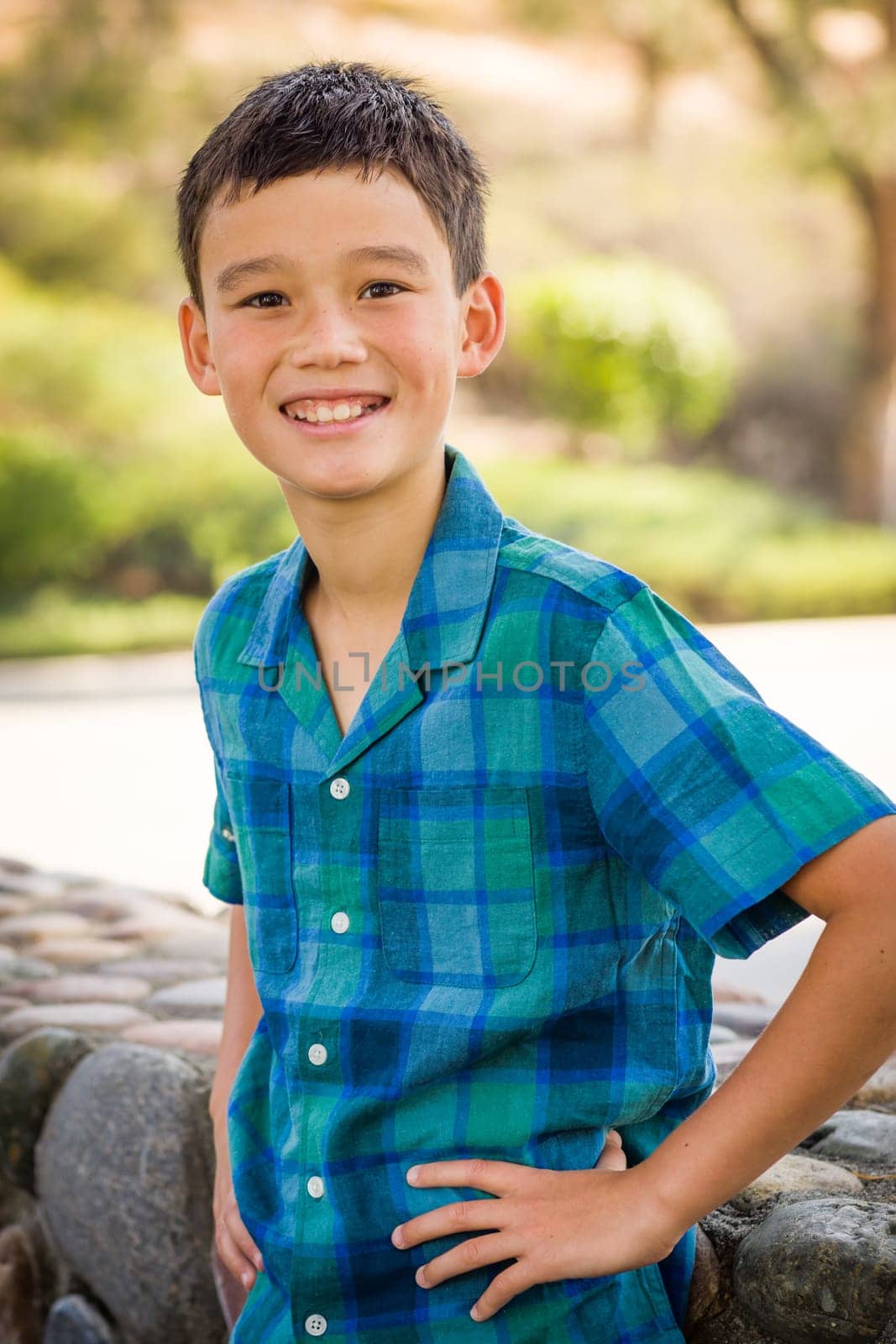 Outdoor portrait of a biracial Chinese and Caucasian boy.