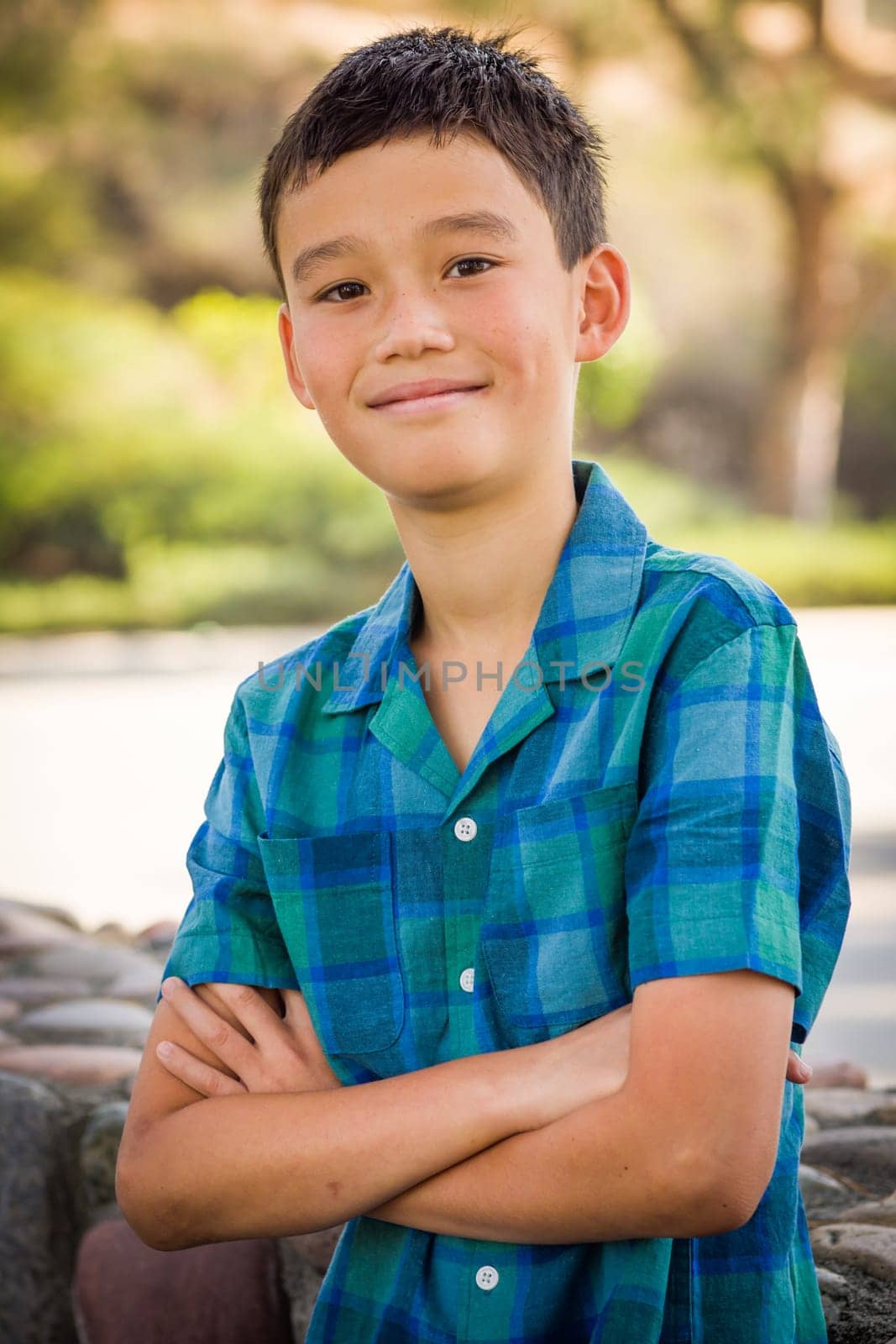 Outdoor portrait of a biracial Chinese and Caucasian boy.