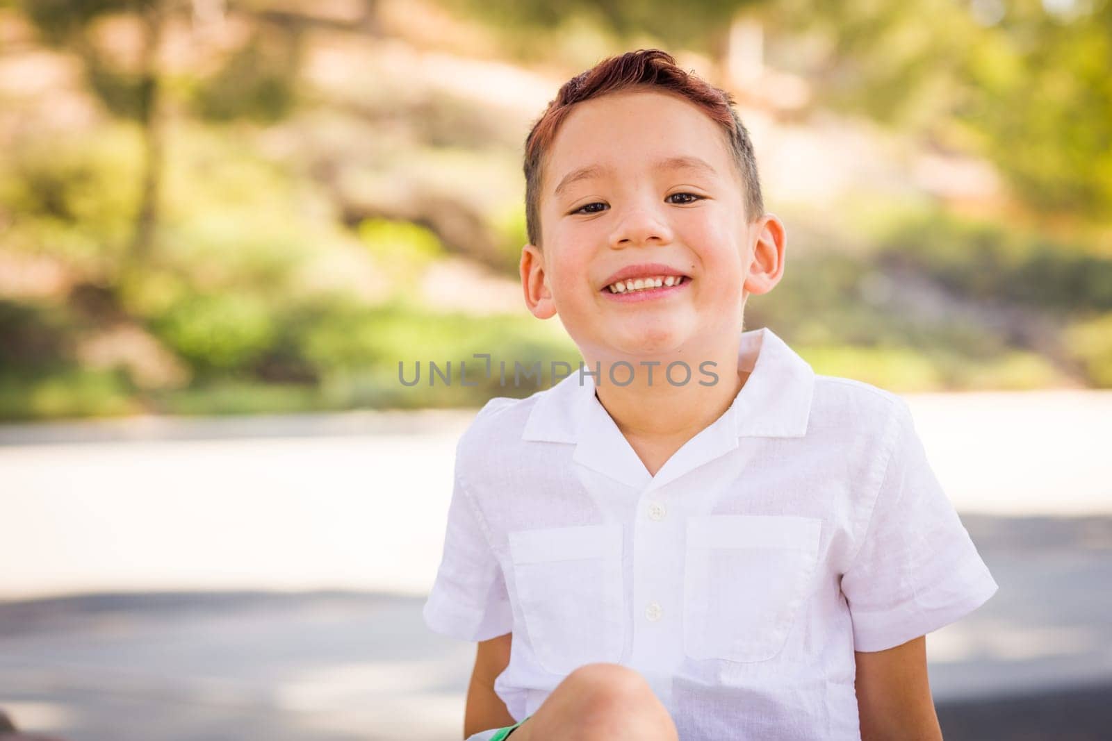 Outdoor portrait of a biracial Chinese and Caucasian boy.