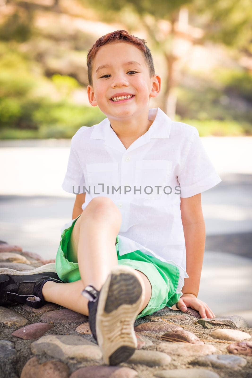 Outdoor portrait of a biracial Chinese and Caucasian boy.
