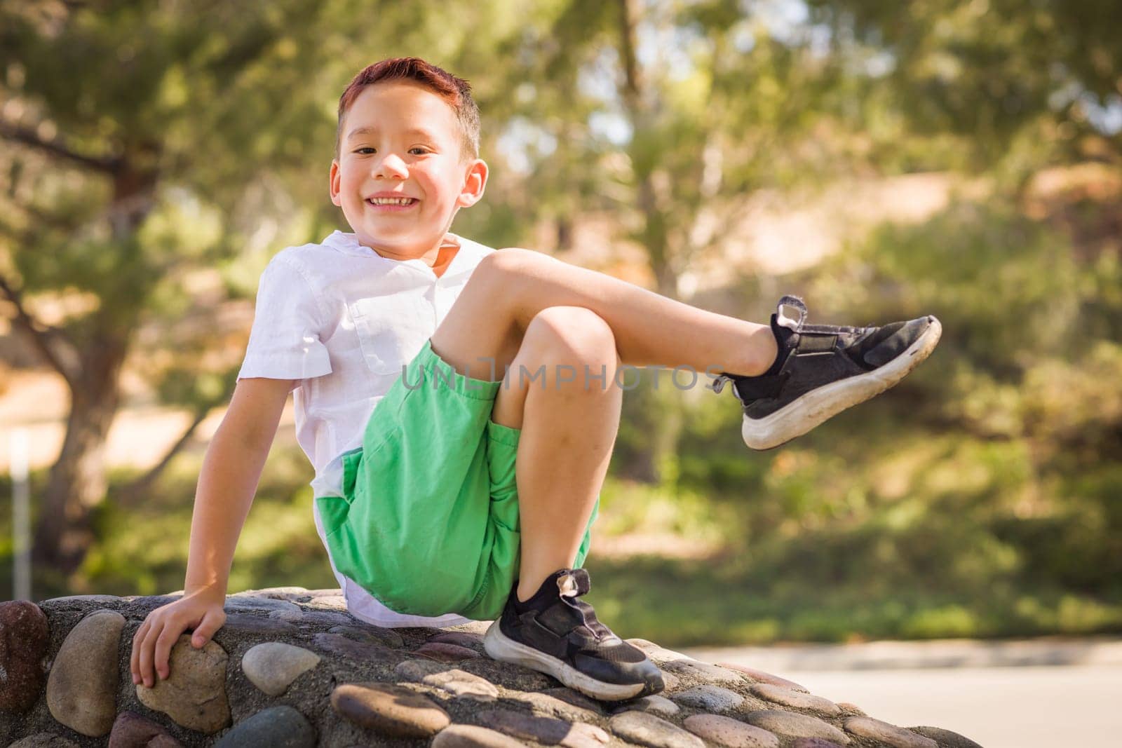 Outdoor portrait of a biracial Chinese and Caucasian boy.