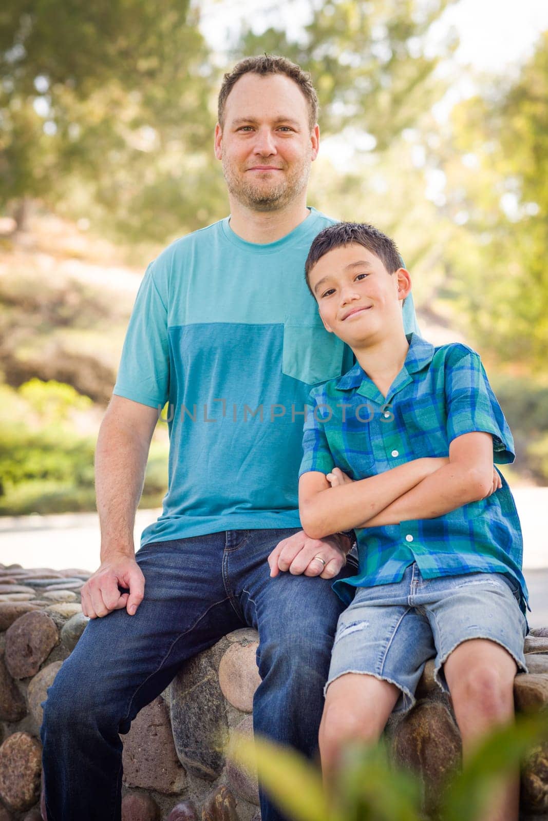 Outdoor portrait of biracial Chinese and Caucasian father and son.