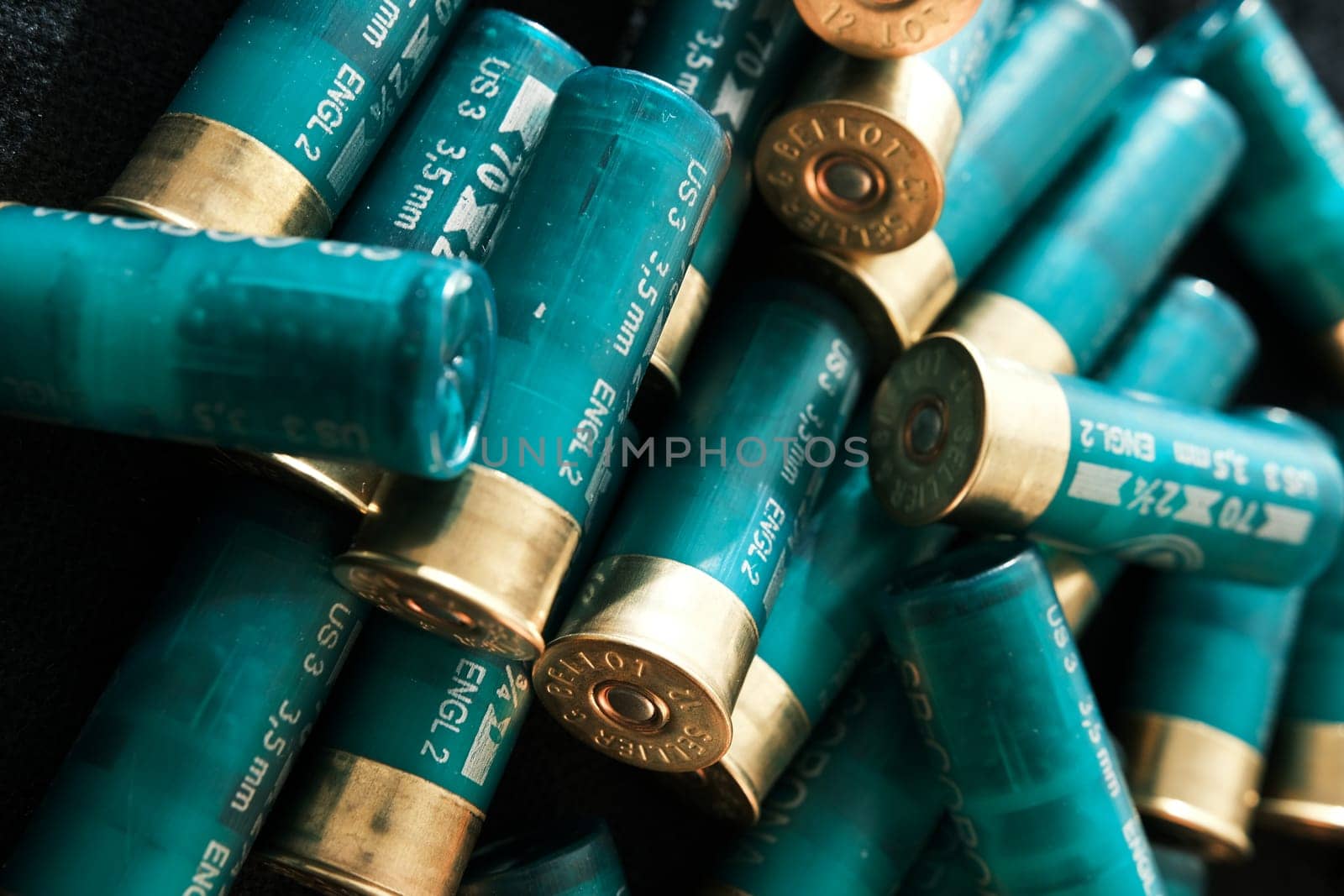Shotgun shells on a black surface. Ammunition for 12 gauge smoothbore weapons. Hunting ammunition. Dark background