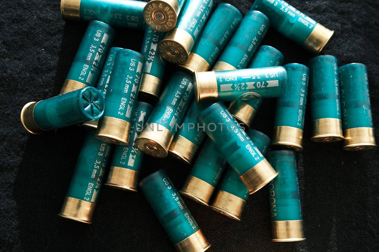 Shotgun shells on a black surface. Ammunition for 12 gauge smoothbore weapons. Hunting ammunition. Dark background