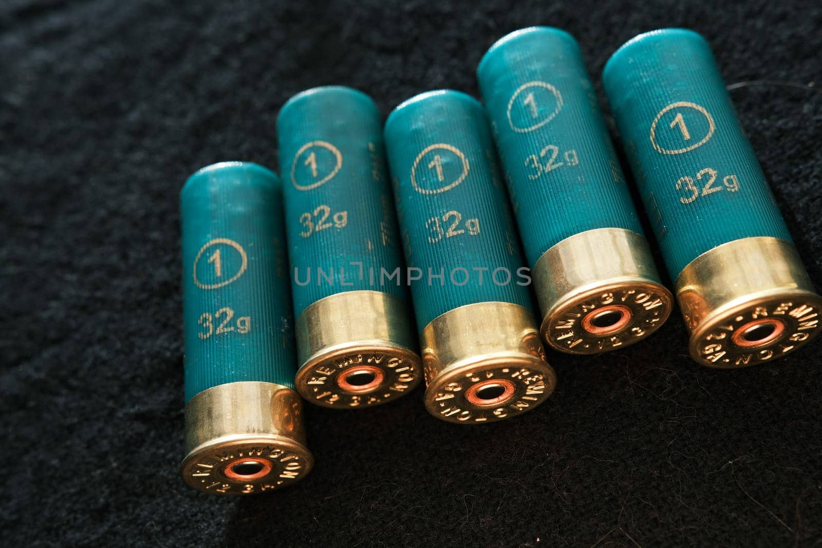 Shotgun shells on a black surface. Ammunition for 12 gauge smoothbore weapons. Hunting ammunition. Dark background