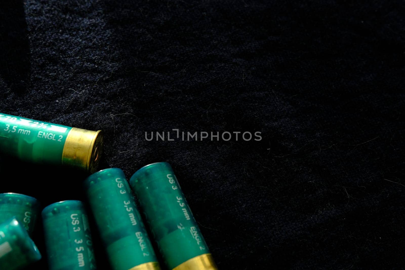 Shotgun shells on a black surface. Ammunition for 12 gauge smoothbore weapons. Hunting ammunition. Dark background