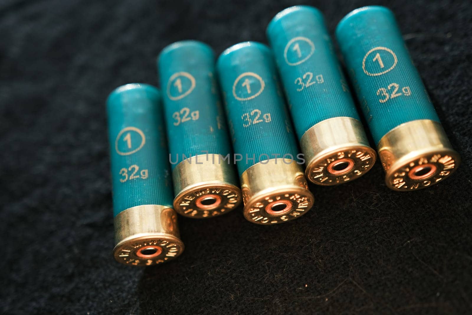 Shotgun shells on a black surface. Ammunition for 12 gauge smoothbore weapons. Hunting ammunition. Dark background