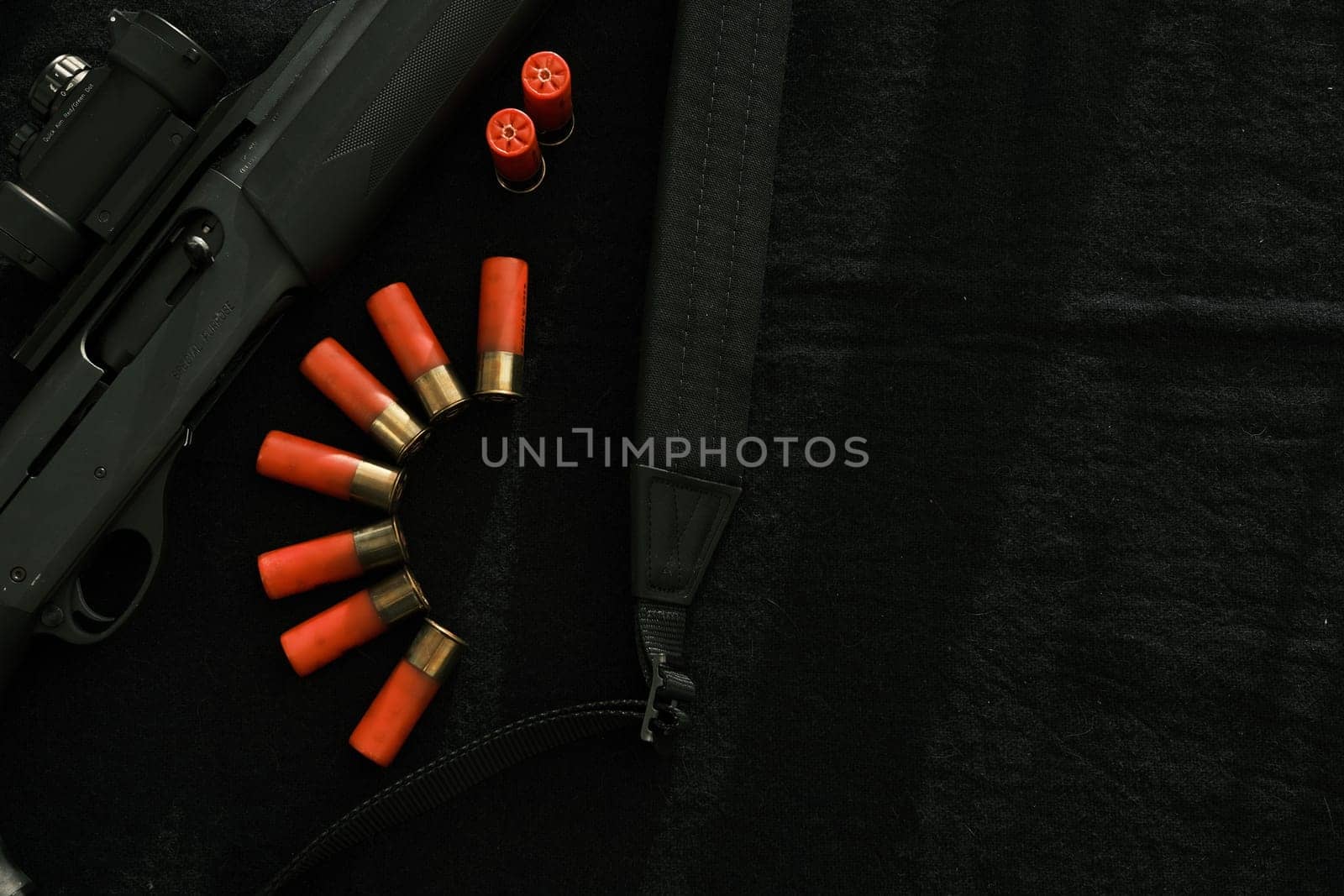 Weapon on black cloth: rifle, shells,top view. Top view of rifle, shells on black cloth background.