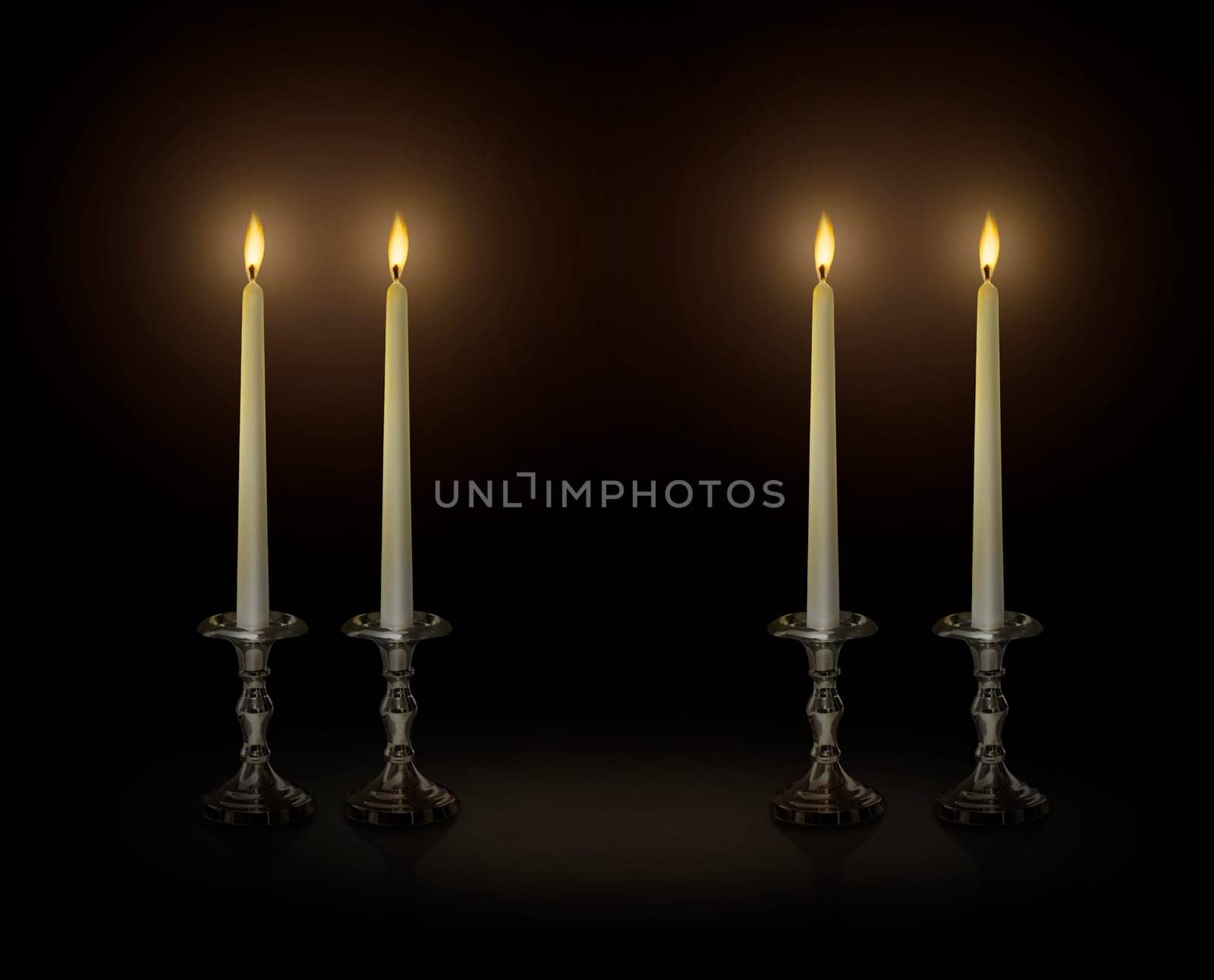 Candle light on a candlestick on a black background