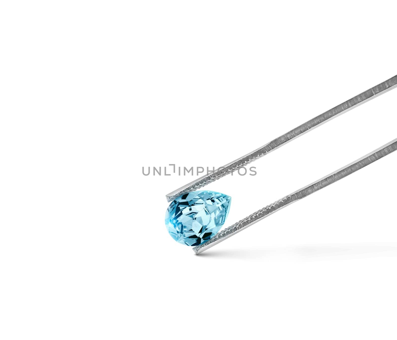 blue diamonds held in tweezers on a white background