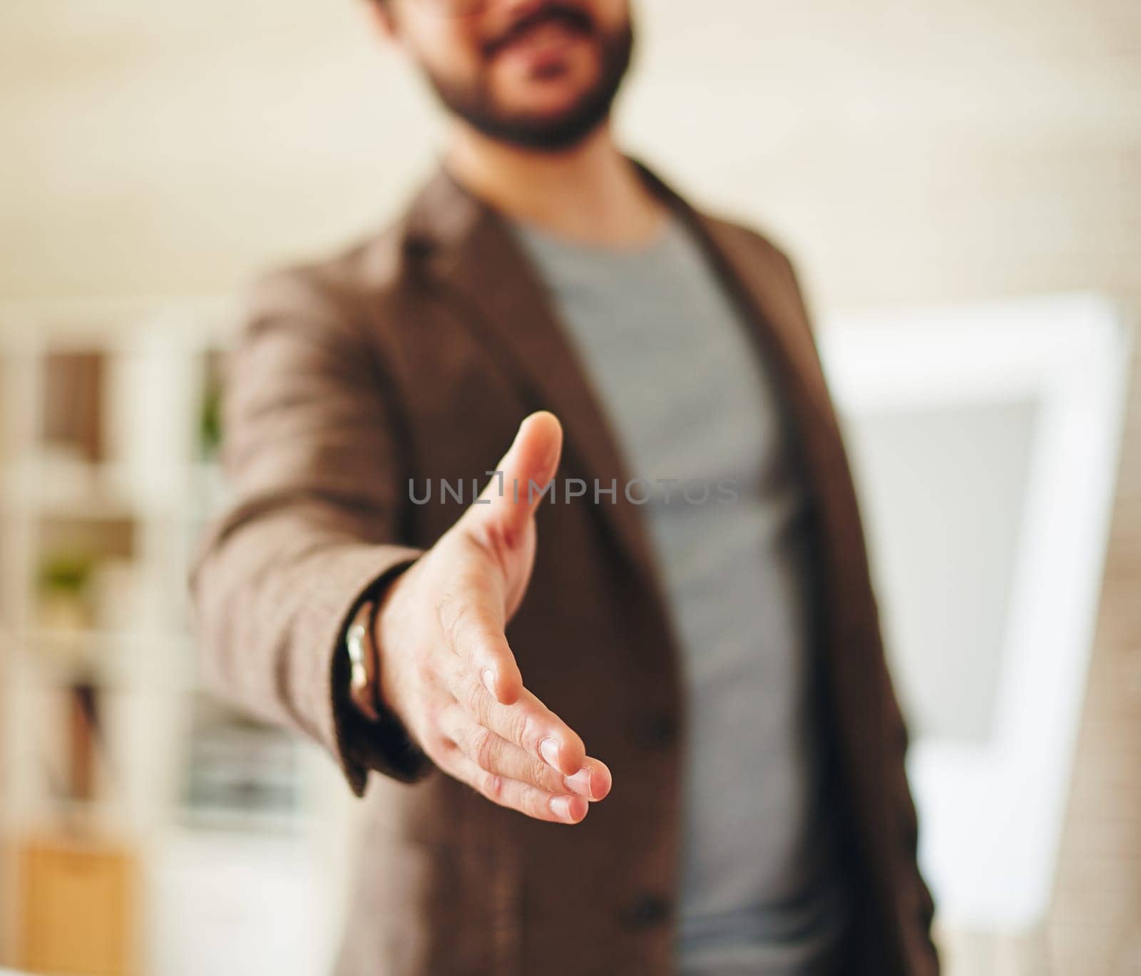 Businessman giving his hand for handshake to partner