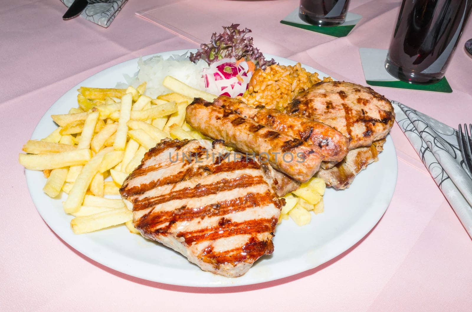 Greek grill plate. Grilled meat with French fries.