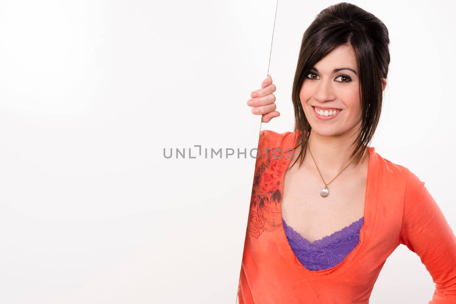 Woman smiles at she stands in between white spaces