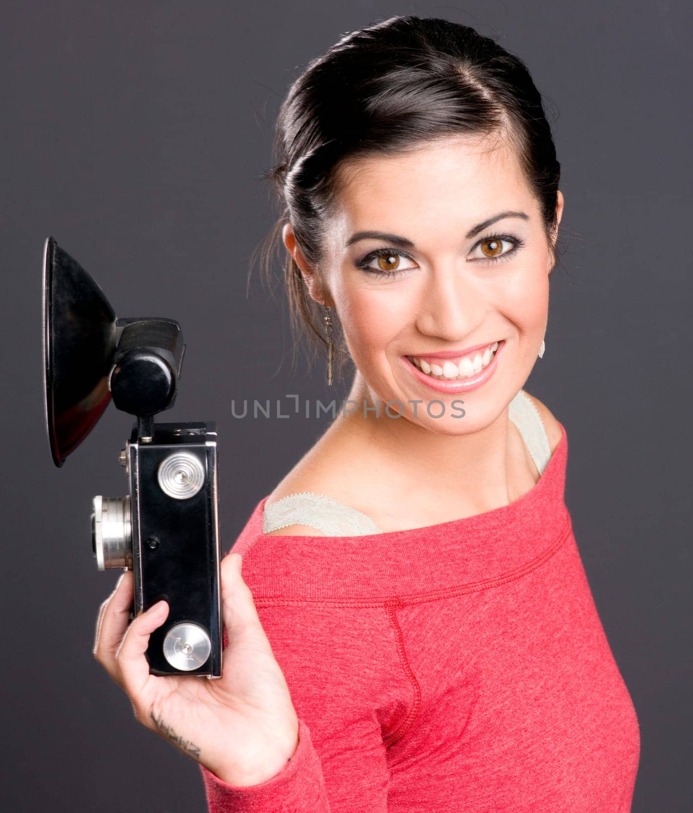 Pretty Woman in red with a vintage camera