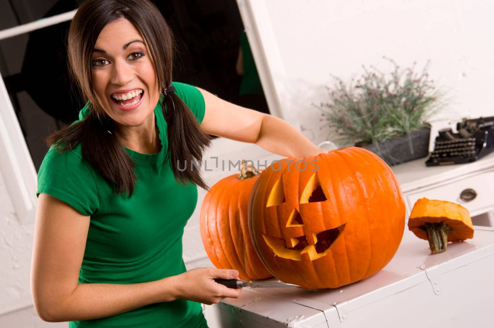 Joyful Pumpkin Carving Woman Cleans inside of Halloween Gourd