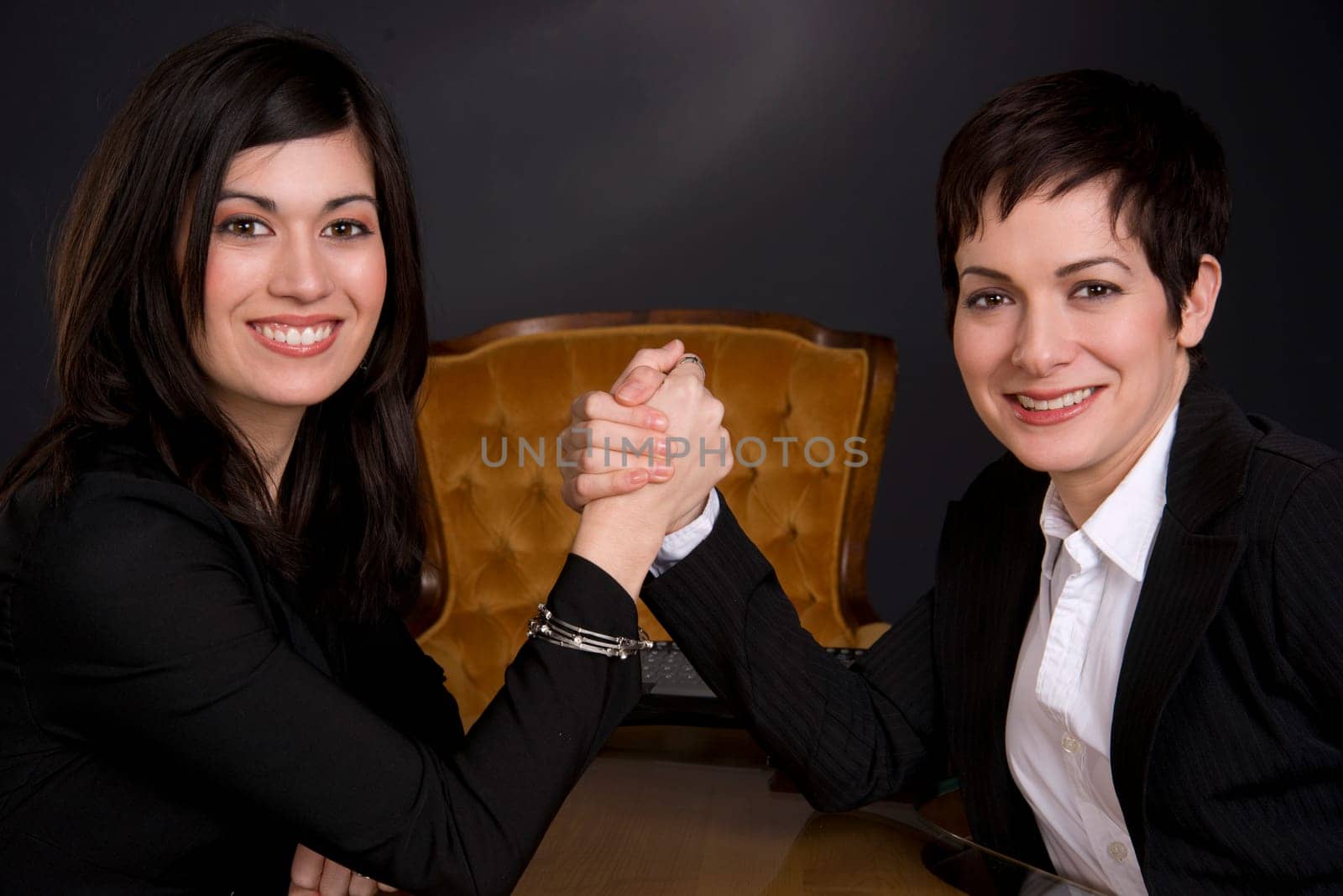 Female Business Associates Arm Wrestling