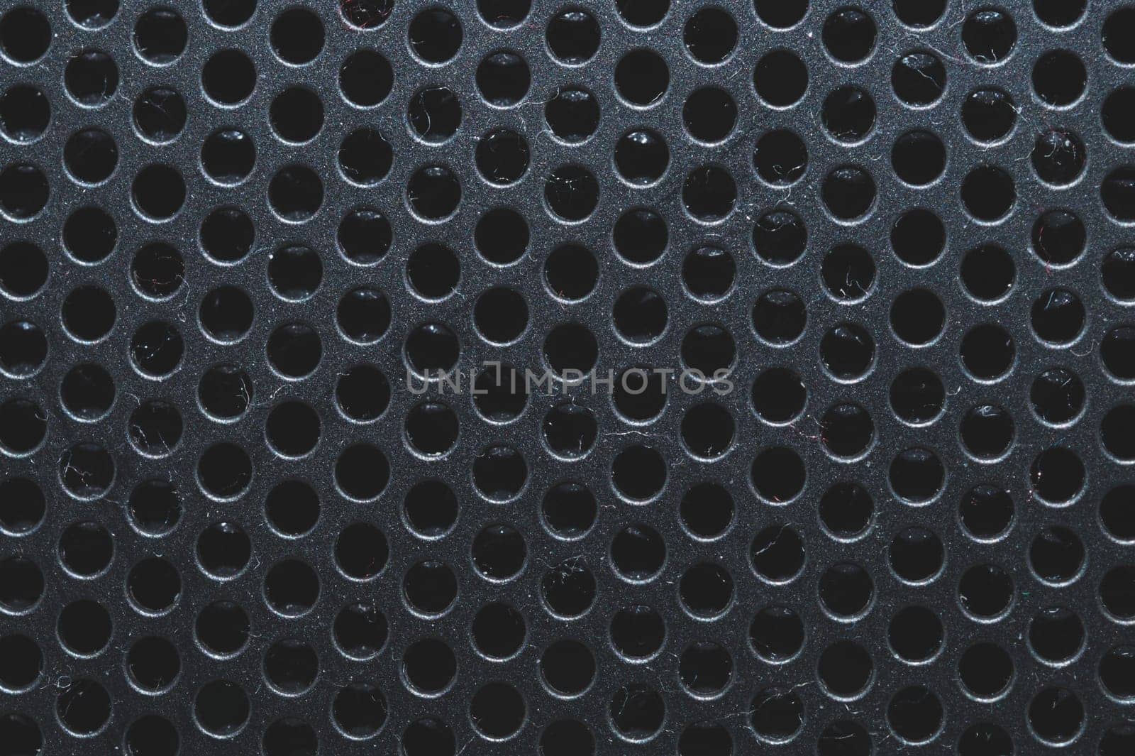 Dusty ventilation grid with round holes macro