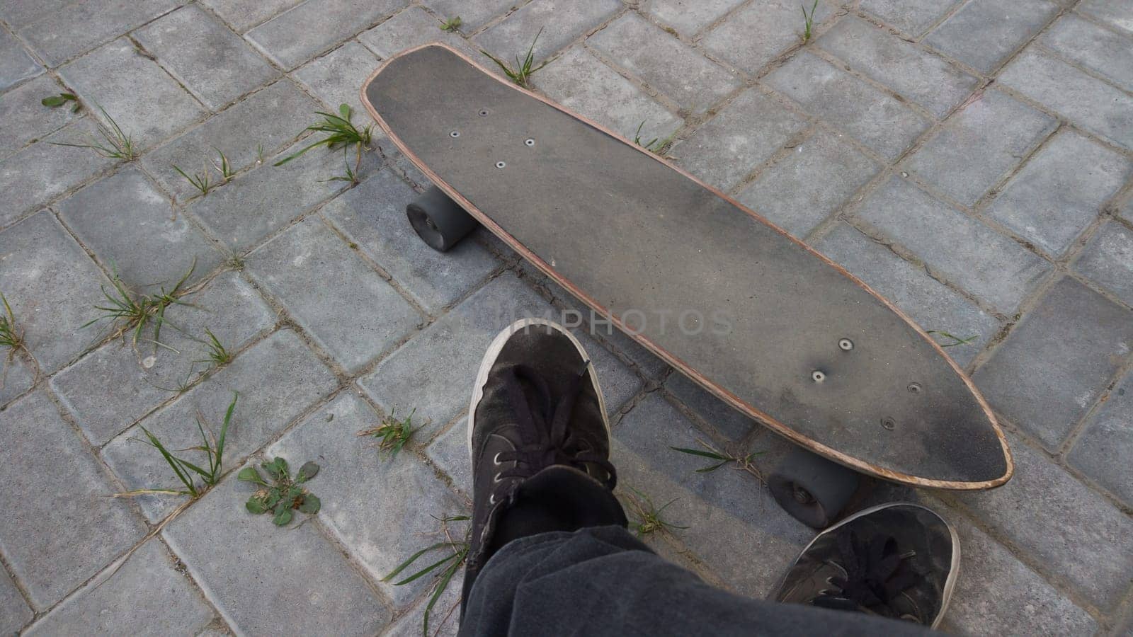 Old used skateboard lies on the ground