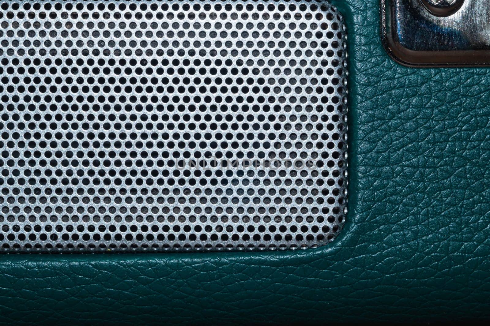 Grid of speaker with round holes. gray protective mesh