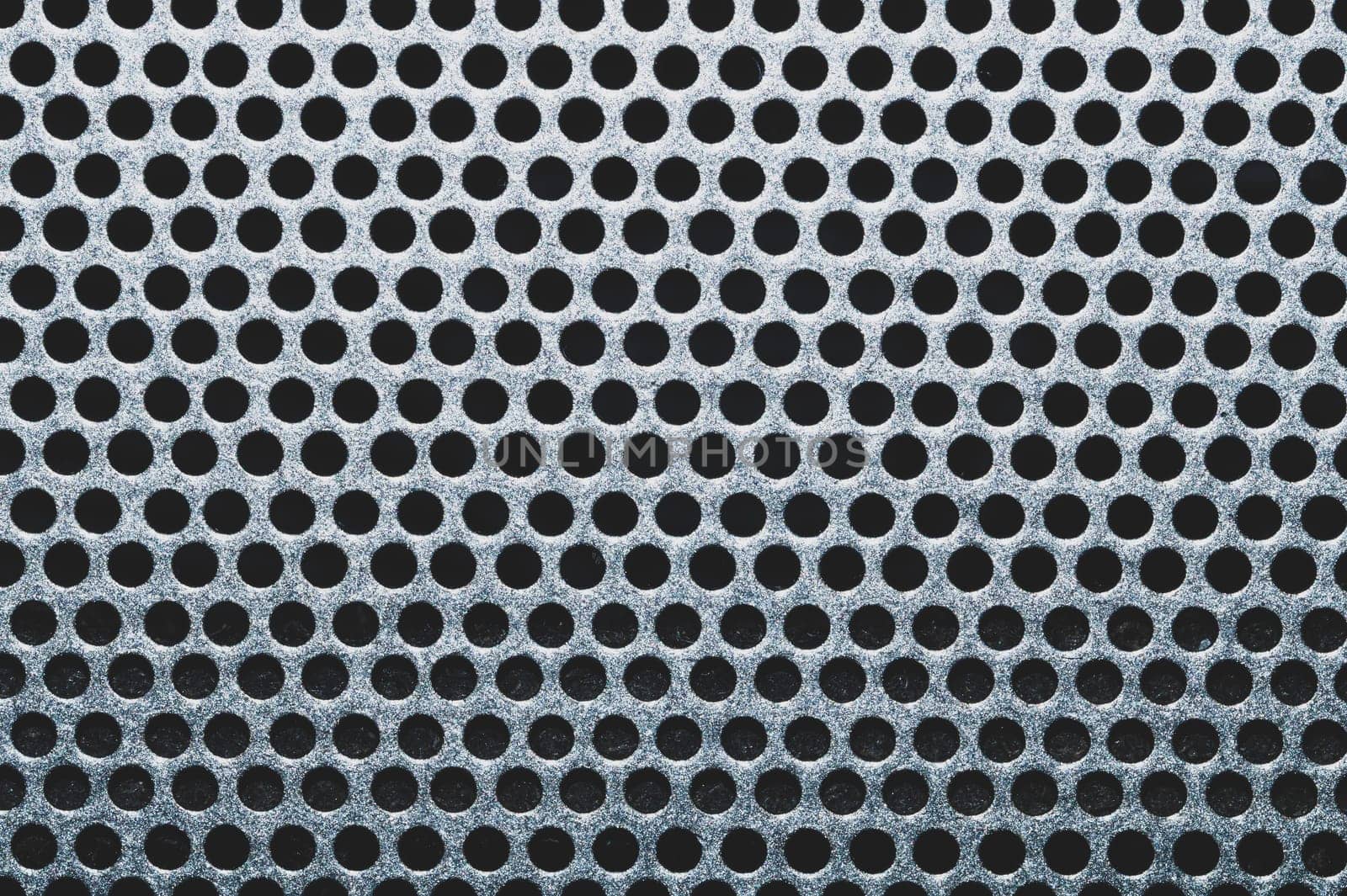 Gray metal grate with round holes. ventilation mesh