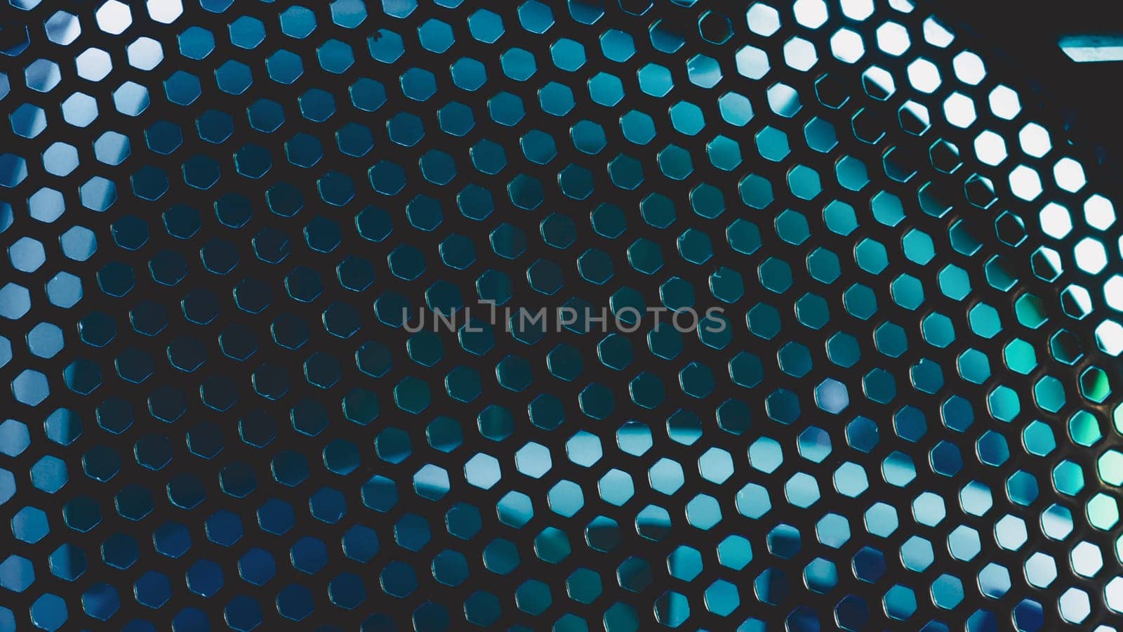 Detail of computer fan with blue color light abstract background. cooler grid close up. rgb led illumination
