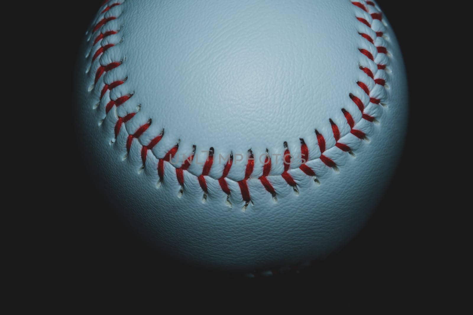 Baseball ball close up on black background