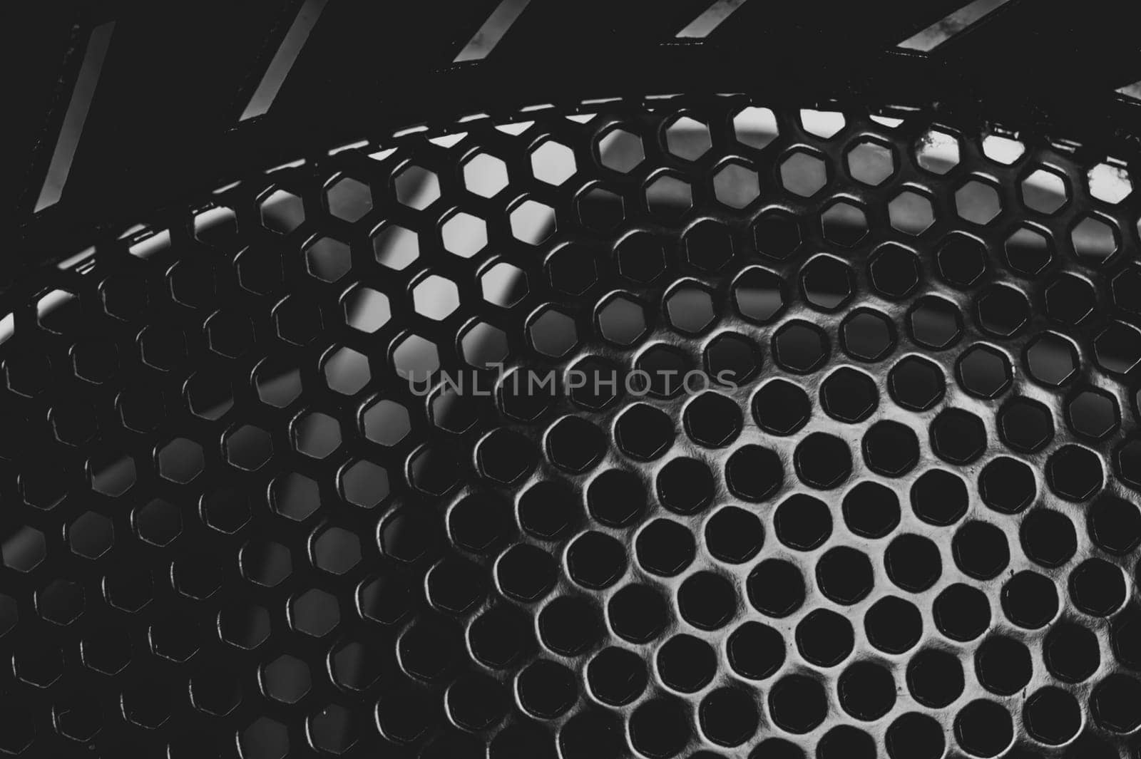 Grid with round holes abstract background. protective mesh of computer cooling system close up