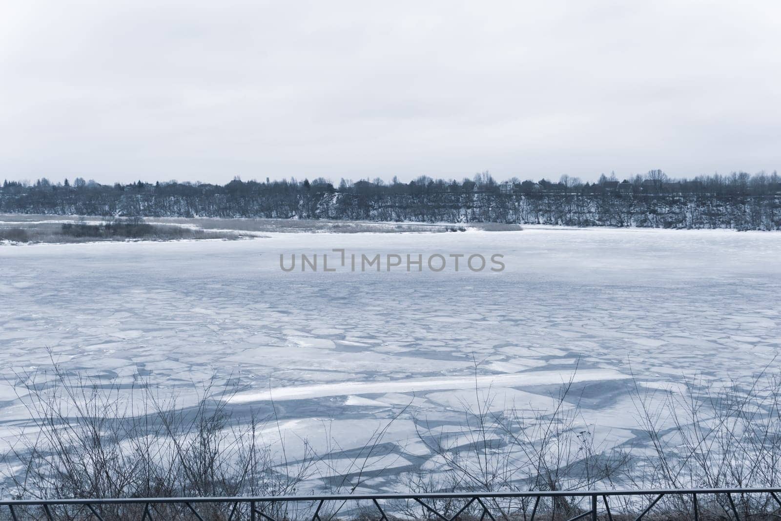 Frozen river with cracked ice. cold weather