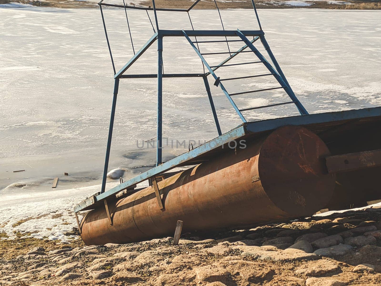 Small pontoon boat with iron construction on the paved shore