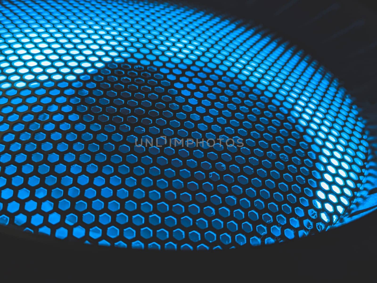 Detail of computer fan with blue color light abstract background. cooler grid close up. rgb led illumination