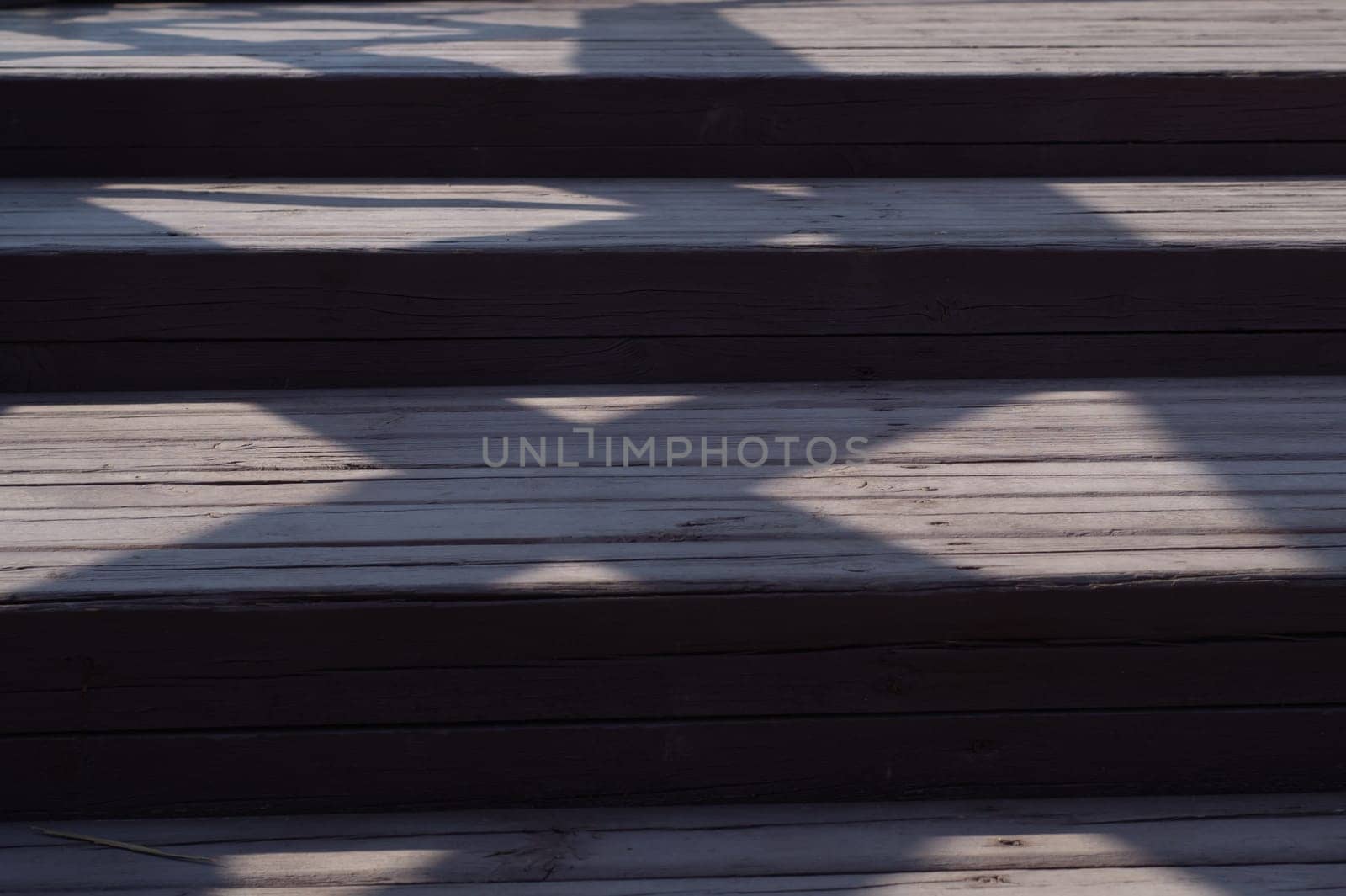 Wooden staircase with shadows close up