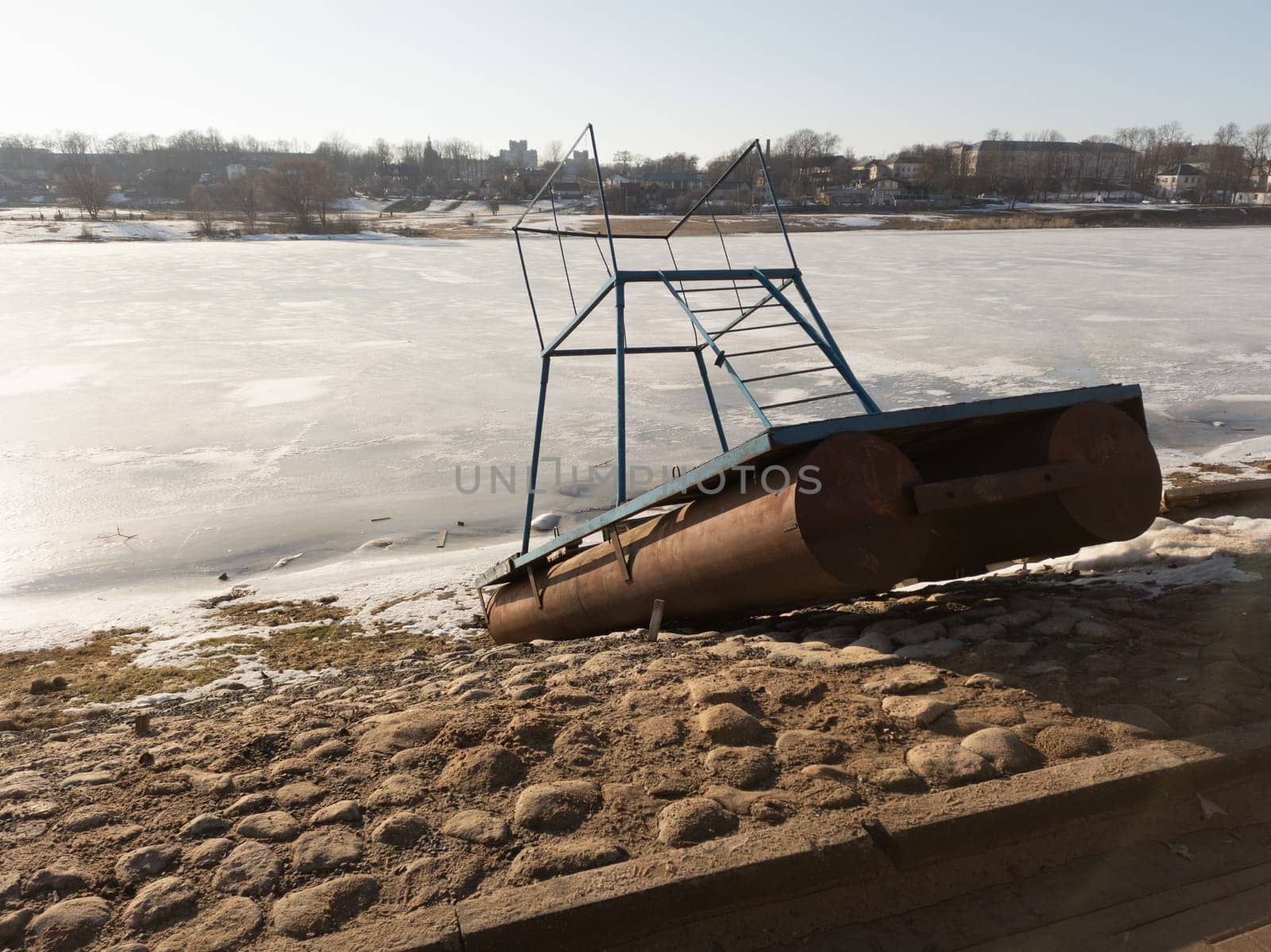 Small pontoon boat with iron construction on the paved shore