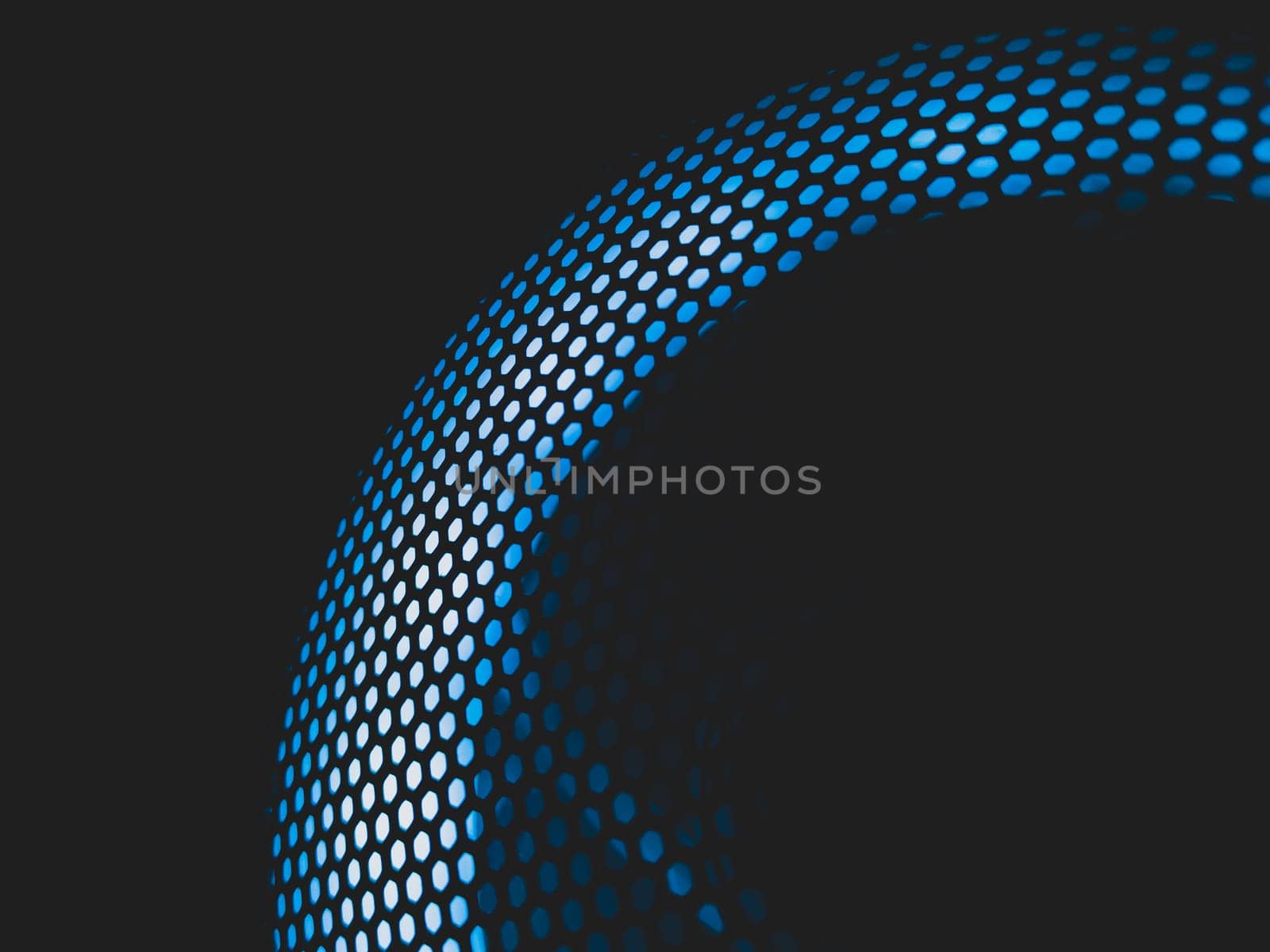 Modern abstract background with blue light. cooler of processor with neon lights luminous through the protective grid in the dark