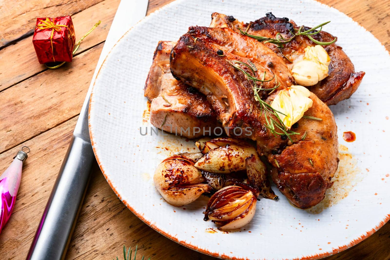 Appetizing fried pork on the bone and caramelized onions. Fried pork loin.