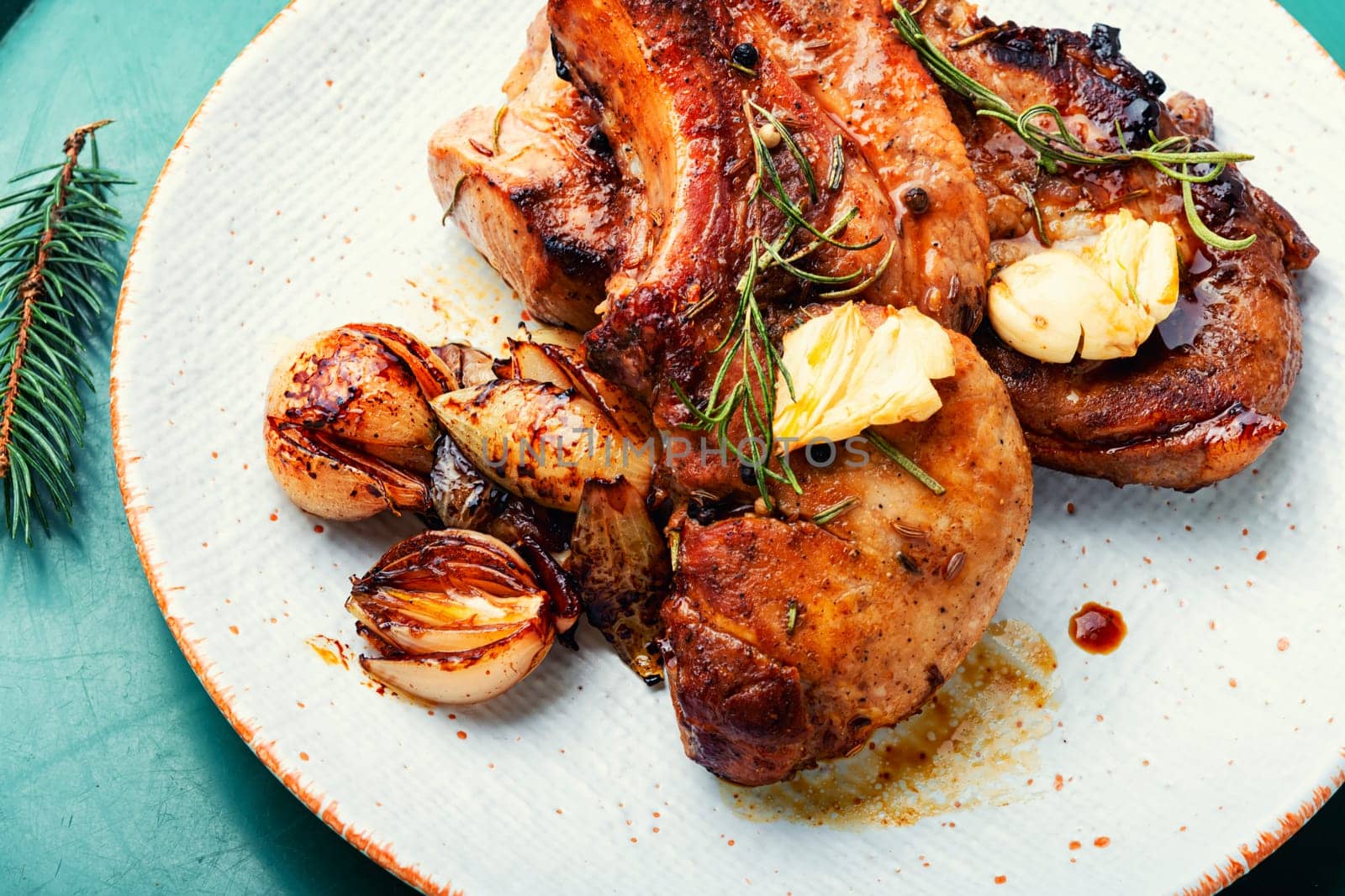 Appetizing fried pork on the bone and caramelized onions. Fried pork loin.