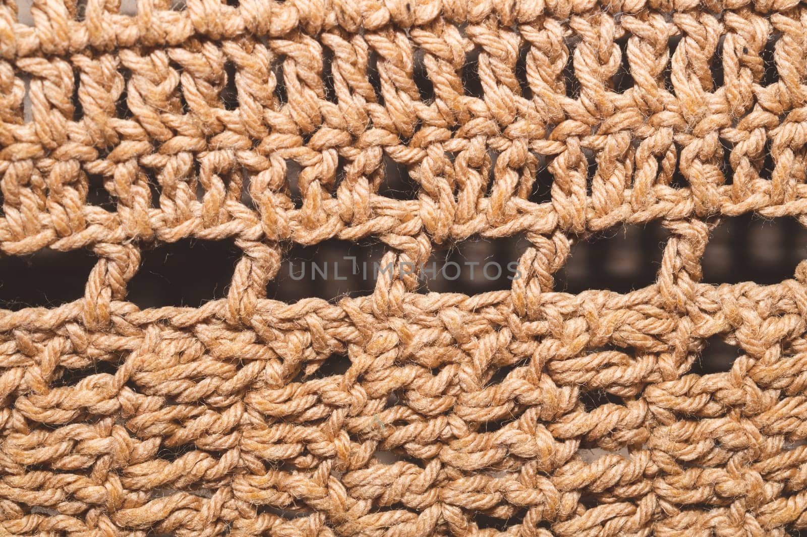 Knitted background from jute threads. weaving texture. woven backdrop close up