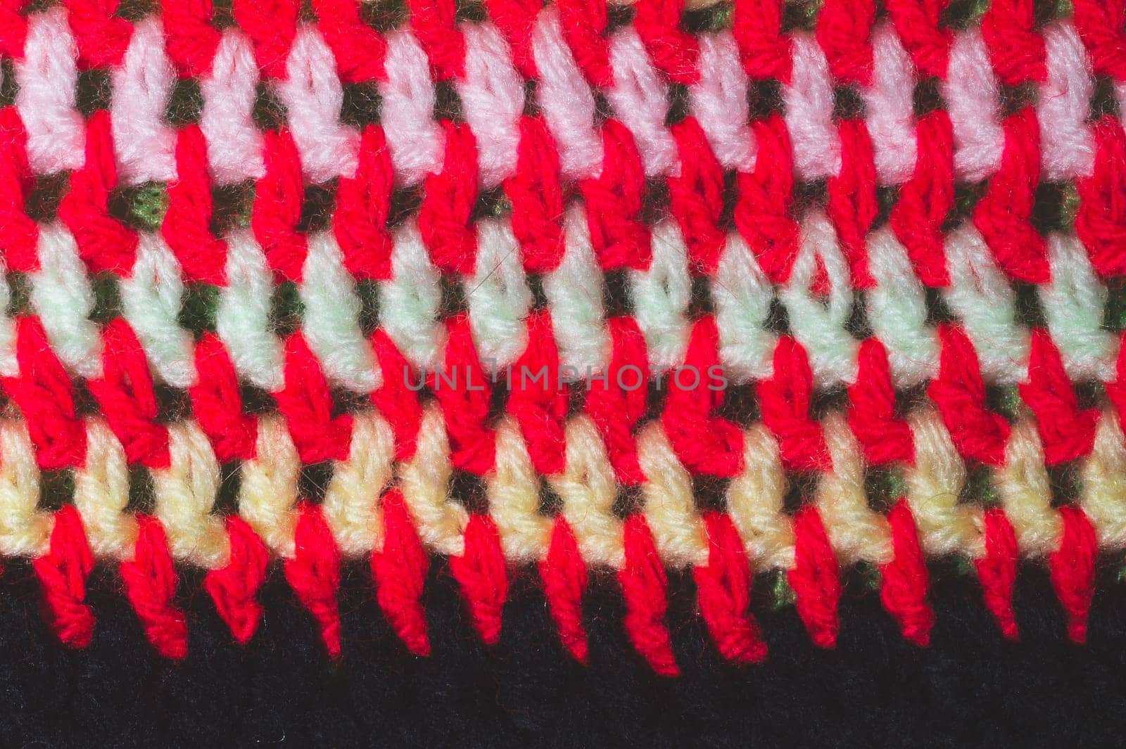Knitted background from colored threads close up. homemade needlework