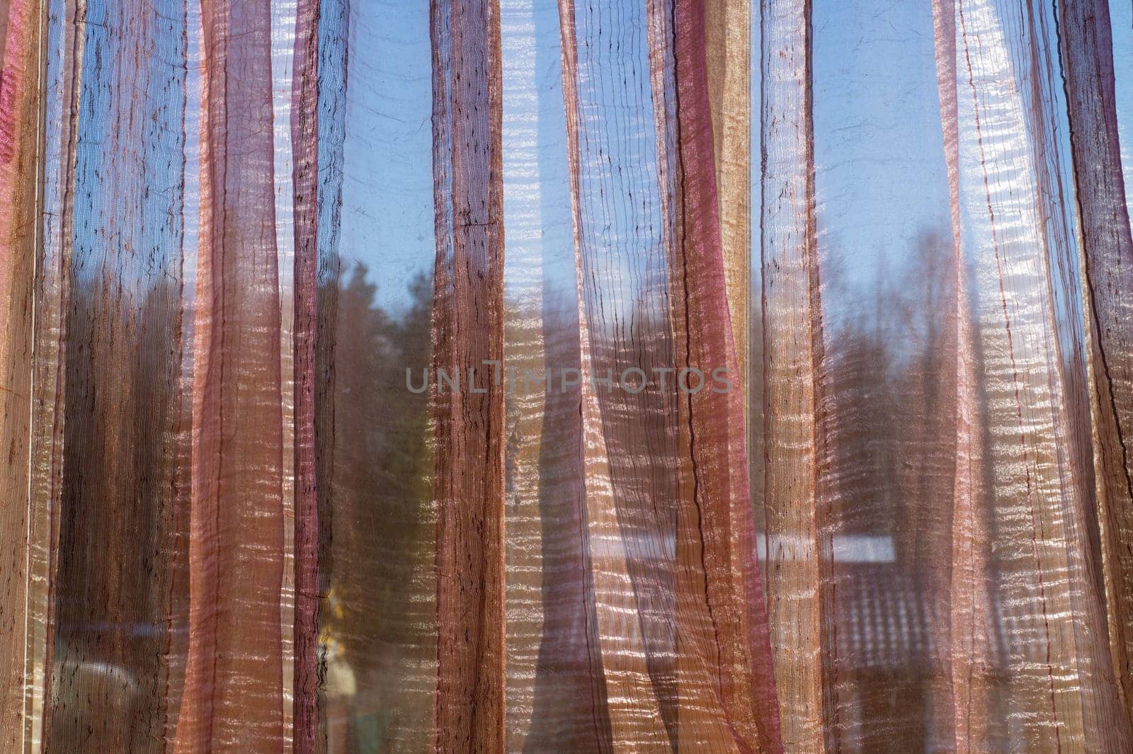 Sunlight shines through transparent curtain. morning light