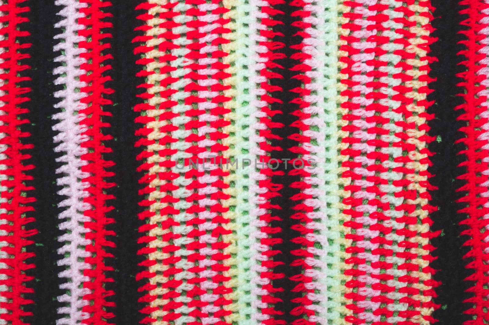 Knitted background from colored threads close up