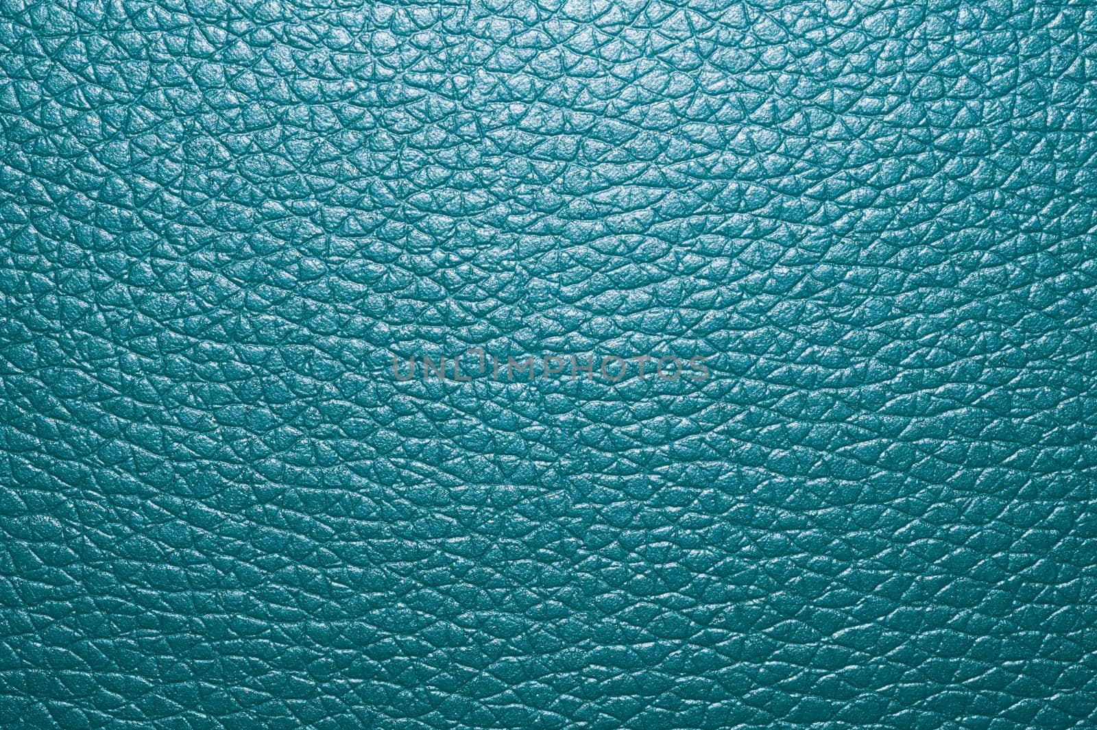 Blue colored leather surface background close up