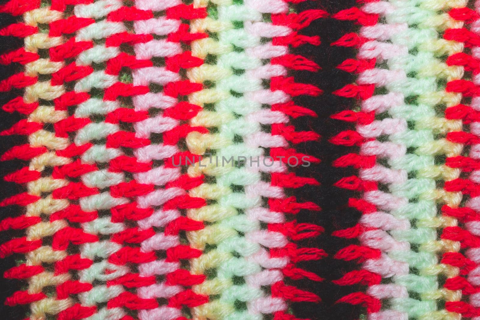 Knitted background from colored threads close up. homemade needlework